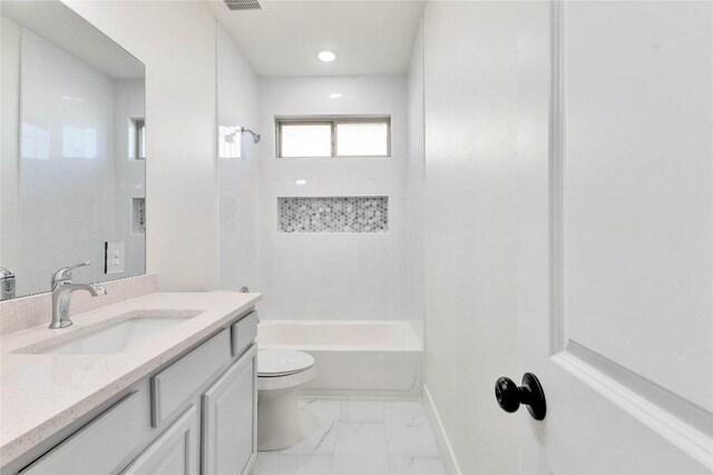 full bathroom with toilet, tiled shower / bath combo, and vanity