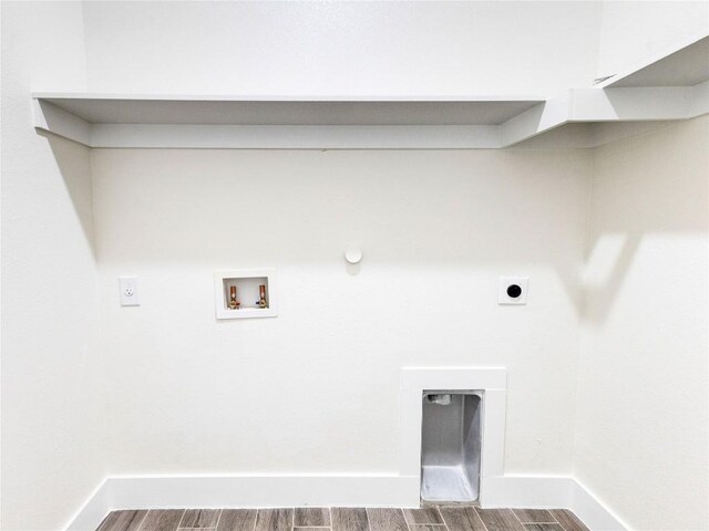 clothes washing area with hookup for a washing machine, hookup for a gas dryer, hardwood / wood-style floors, and hookup for an electric dryer