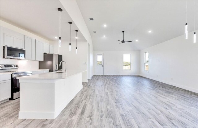 kitchen featuring light wood-type flooring, white cabinets, and appliances with stainless steel finishes