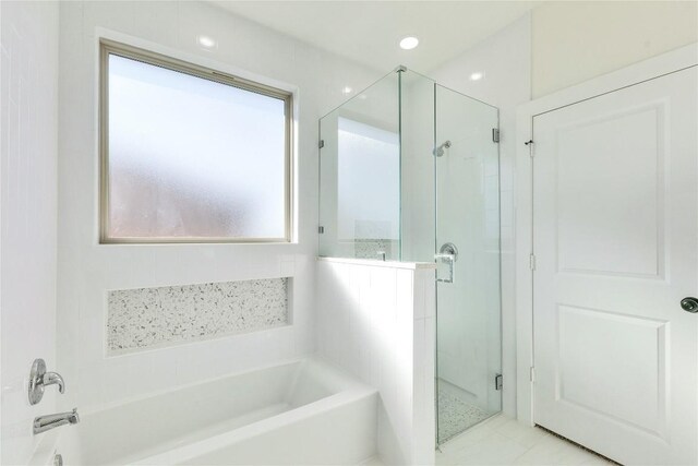 bathroom featuring tile patterned flooring and plus walk in shower