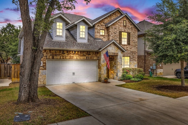 view of front of house featuring a yard and a garage