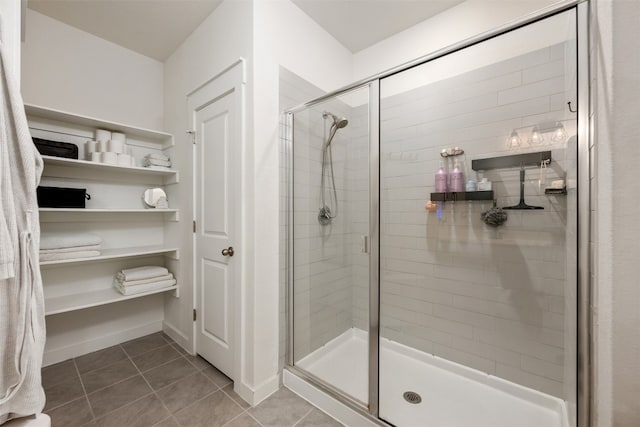 bathroom featuring tile patterned floors and a shower with door