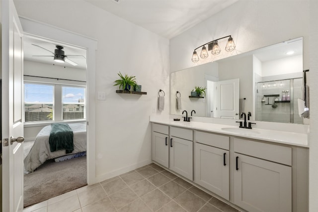 bathroom featuring tile patterned floors, ceiling fan, an enclosed shower, and vanity