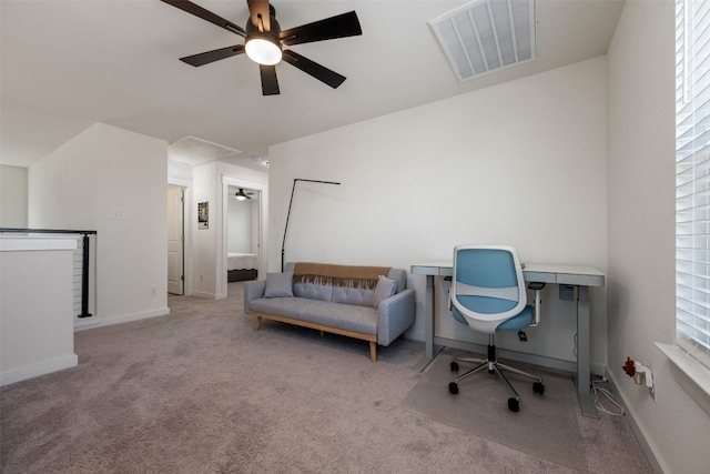 carpeted office space featuring ceiling fan