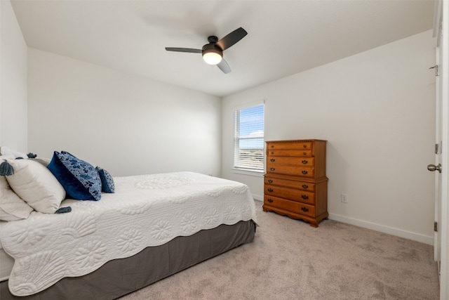 bedroom featuring light colored carpet and ceiling fan