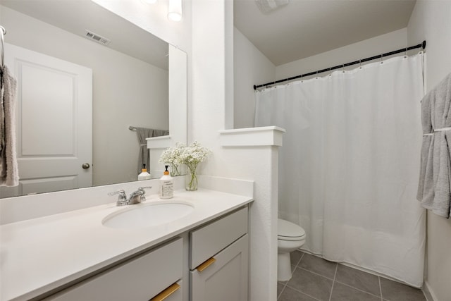 bathroom with walk in shower, tile patterned flooring, vanity, and toilet