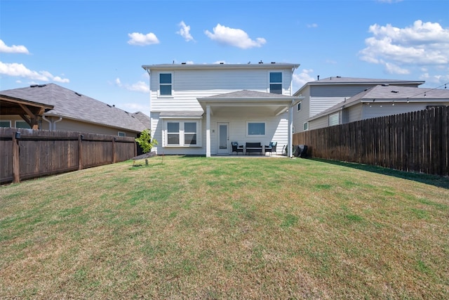 back of property featuring a lawn and a patio area