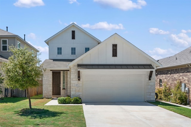 view of front of property with a garage and a front yard