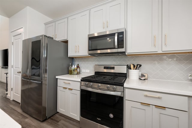 kitchen with dark hardwood / wood-style flooring, white cabinetry, appliances with stainless steel finishes, and tasteful backsplash