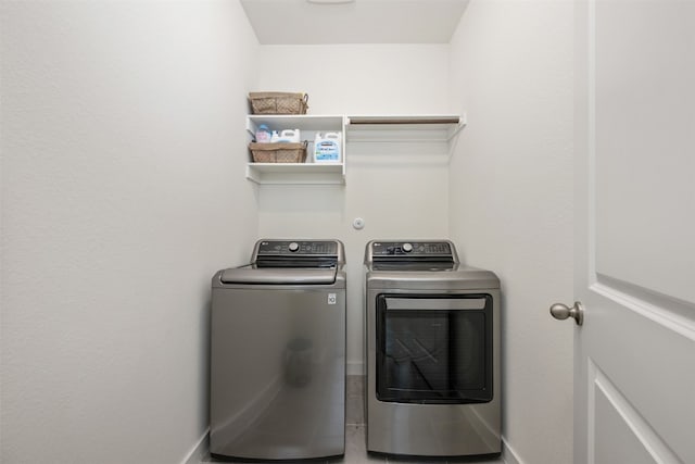 clothes washing area featuring separate washer and dryer