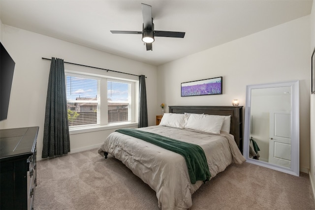 bedroom featuring light colored carpet and ceiling fan