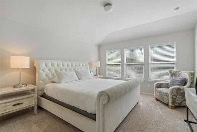 carpeted bedroom with vaulted ceiling