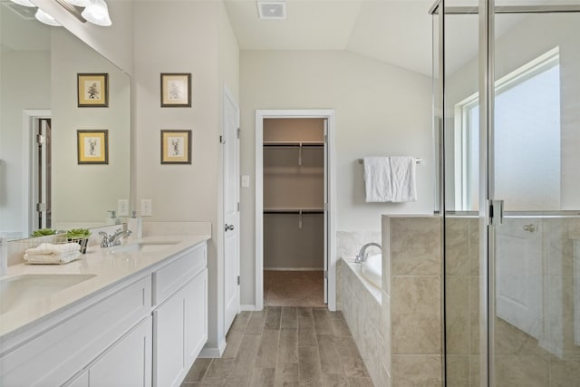 bathroom with lofted ceiling, separate shower and tub, wood-type flooring, and vanity