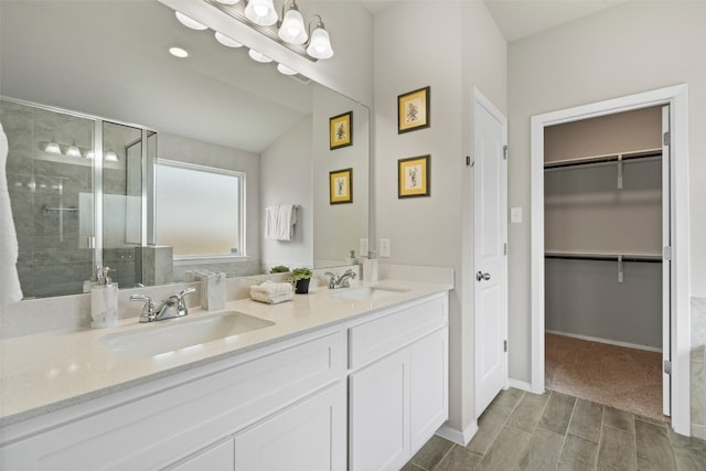 bathroom featuring vanity and a shower with door