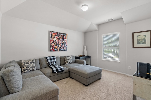 living room with lofted ceiling and carpet