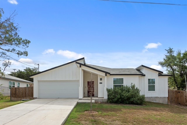 ranch-style home with a garage and a front yard