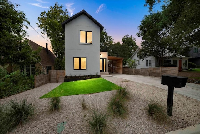 modern home featuring a yard and a carport