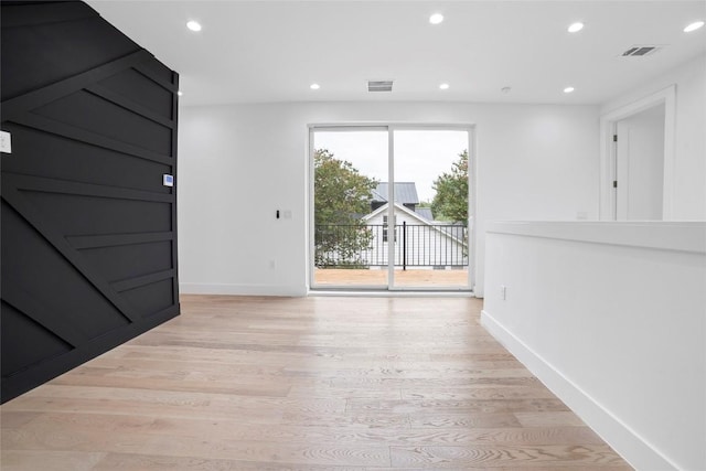 spare room with light hardwood / wood-style flooring