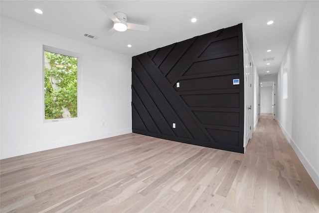 spare room with ceiling fan and light hardwood / wood-style flooring