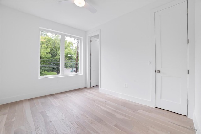 spare room with light wood-type flooring and ceiling fan