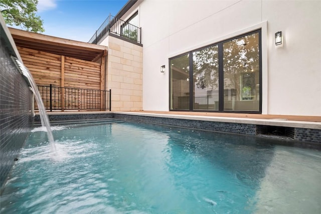 view of swimming pool featuring pool water feature