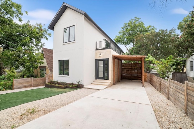 exterior space featuring a balcony and a lawn