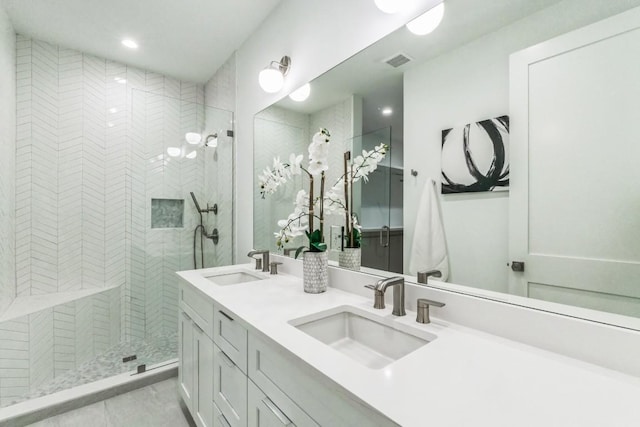 bathroom with vanity and a tile shower