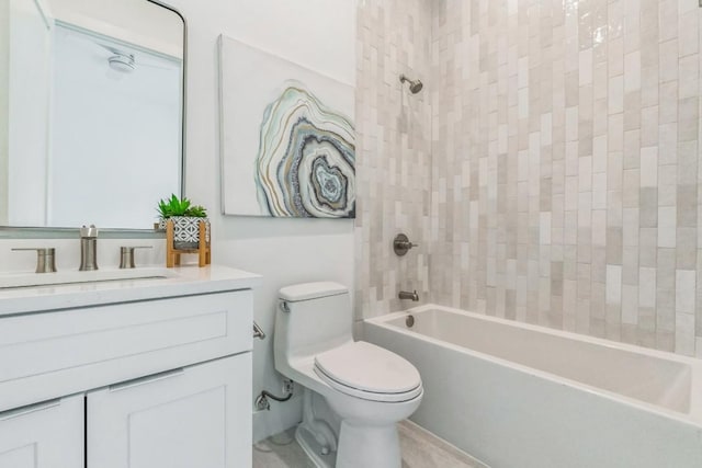 full bathroom with vanity, tiled shower / bath combo, and toilet