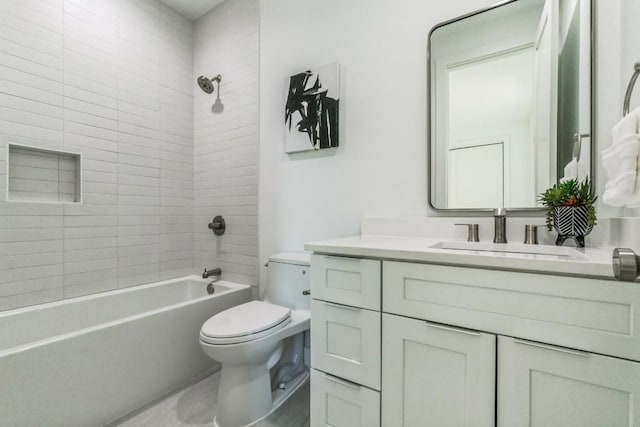 full bathroom featuring vanity, toilet, and tiled shower / bath