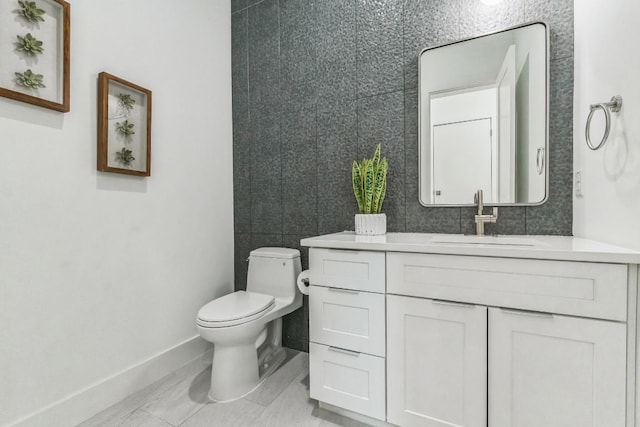 bathroom featuring tile patterned floors, vanity, and toilet