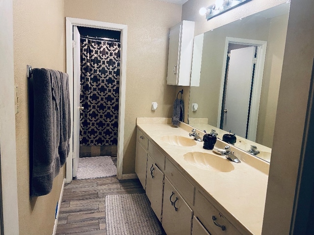 full bathroom featuring curtained shower, wood finished floors, and vanity