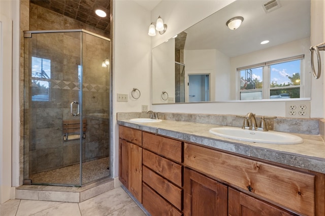 bathroom with vanity, tile patterned floors, and a shower with door