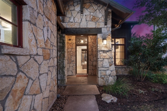 view of exterior entry at dusk