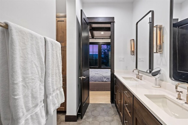 2105 Keeneland Cv Unit 6, Spicewood, TX 78669 - full bathroom featuring connected bathroom, double vanity, a sink, and tile patterned flooring