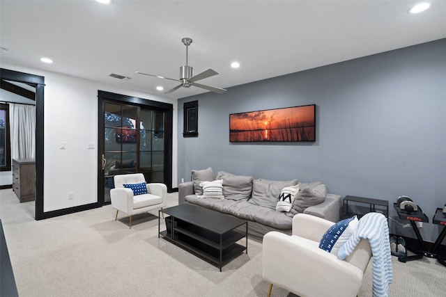 carpeted living room featuring ceiling fan