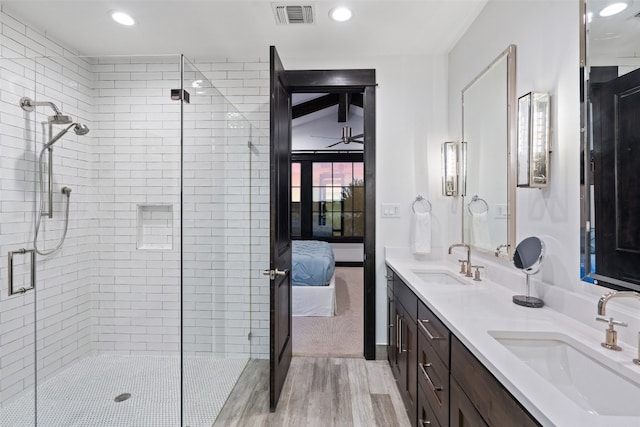 bathroom with vanity, a shower with shower door, and hardwood / wood-style floors