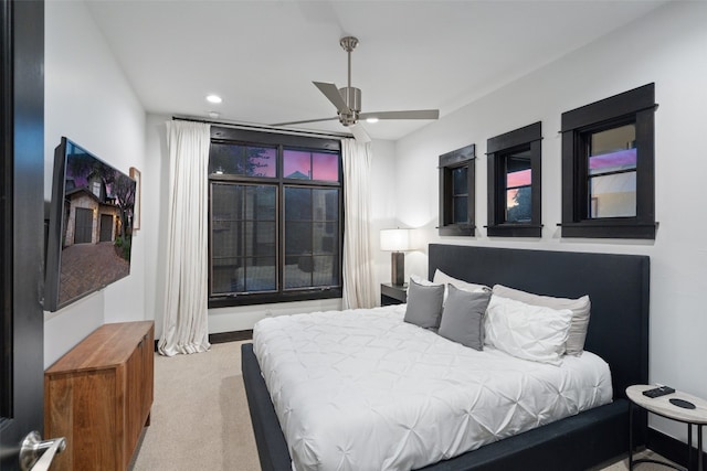 bedroom with light colored carpet and ceiling fan