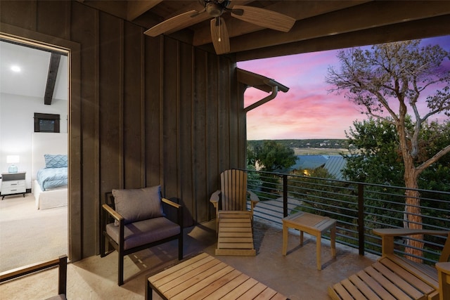 patio terrace at dusk with a balcony and ceiling fan