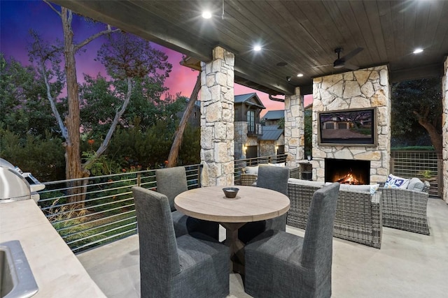 2105 Keeneland Cv Unit 6, Spicewood, TX 78669 - view of patio / terrace with grilling area, ceiling fan, and an outdoor living space with a fireplace