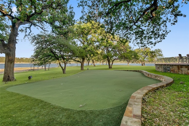 view of community with a lawn and a water view