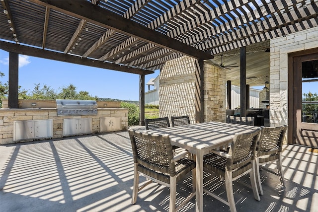 view of patio with a grill, a pergola, and an outdoor kitchen