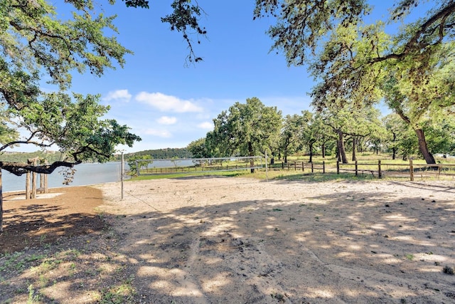 view of yard with a water view and volleyball court