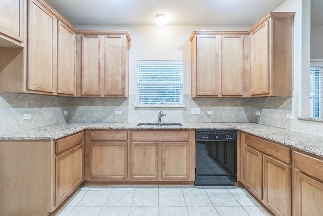 kitchen with backsplash, light stone counters, sink, black dishwasher, and light tile patterned flooring