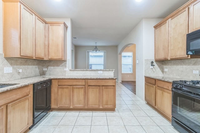 kitchen featuring black appliances, pendant lighting, backsplash, kitchen peninsula, and light stone counters