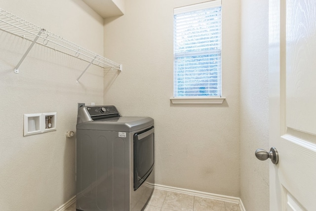 laundry area featuring light tile patterned floors and washer / clothes dryer