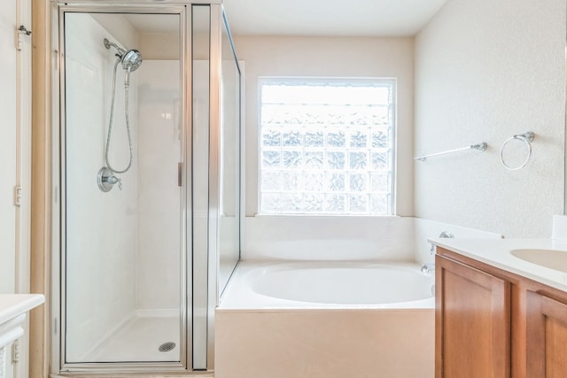 bathroom featuring vanity and plus walk in shower