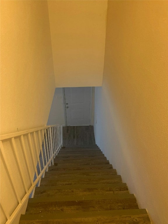 staircase with wood finished floors