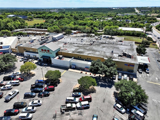 birds eye view of property featuring a wooded view