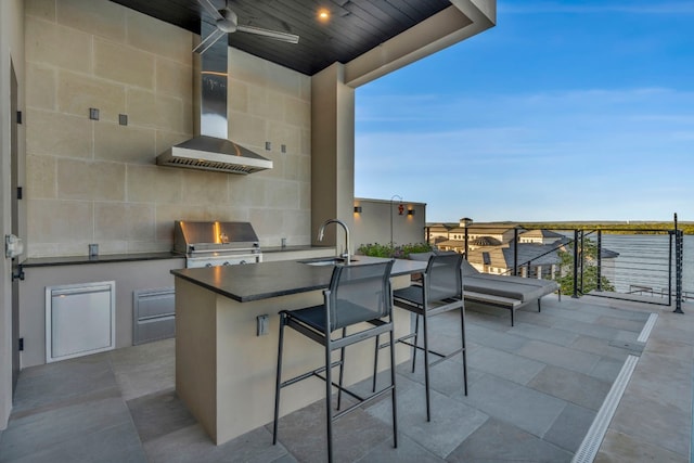 view of patio with a water view, ceiling fan, sink, and area for grilling