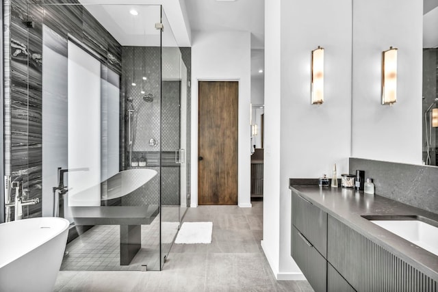 bathroom featuring vanity and separate shower and tub